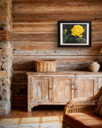 Framed original cactus flower painting by Kris Horton in a rustic living room