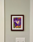 Purple crocus flower painting by Kris Horton hanging on a wall.