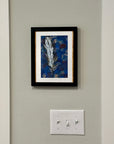 A Feathered Thought painting by Kris' Artworks hanging on a wall.