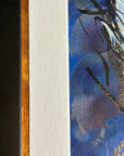 Close up detail of the copper and gold metallic between the frame and the white matting of the painting 'A Feathered Thought' by Kris Horton.
