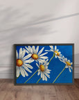 Black framed Daisy Days daisy painting by Kris Horton with blue background wall art.