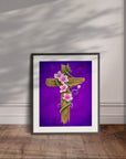 Framed artwork by Kris Horton of a wooden cross with pink flowers on a purple background, displayed leaning on a wall.