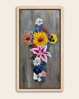 Framed artwork of a cross made of colorful flowers with a grey background by Kris Horton.