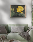 Living room with a green sofa, round wooden coffee table, and framed canvas artwork of a yellow cactus flower painting by Kris Horton .