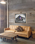My America painting by Kris Horton hanging on a living room wall, Americana painting of an old barn, old chevy truck, with an American Flag.