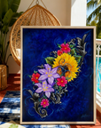 Framed artwork by Kris Horton, of colorful flowers on a patio near a pool.