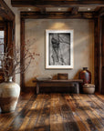 Framed wall art by Kris Horton of Bound an old fence post wrapped with barbwire in a rustic entryway.