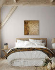 Strength & honor painting by Kris Horton hanging on a wall above a bed