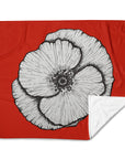 black and white painting of poppy with red background by Kris Horton on a blanket