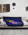 The color of Happiness painting by Kris Horton on a throw blanket draped over a couch in a living room.