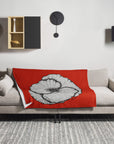 Red poppy color pop painting by Kris Horton on a blanket over a couch