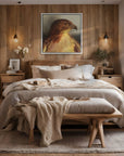 Framed wall art of Watchful a painting by Kris Horton of a red tailed hawk hanging above a bed in a cozy bedroom.