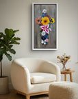 Framed painting of Cross in Bloom by Kris Horton, a cross made of colorful flowers above a chair in a reading nook.