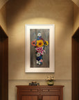 Framed floral painting by Kris Horton of Cross in Bloom a cross made of flowers on a wall above a wooden cabinet hall.