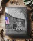 hard cover journal with painting of an old barn and truck with an american flag painting on the cover by Kris Horton