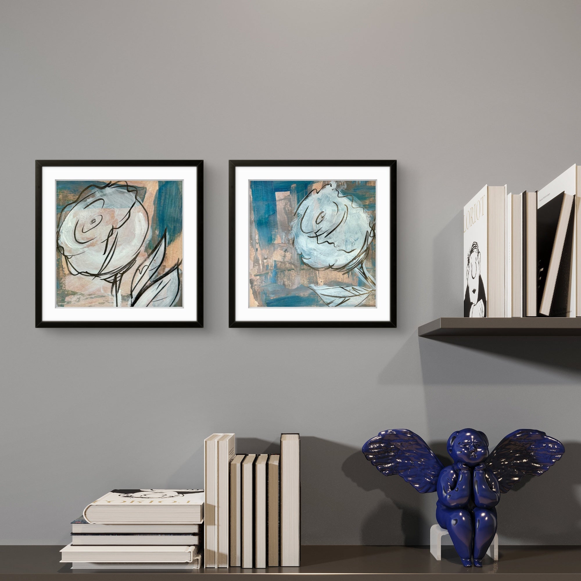 Two framed floral abstract artworks by Kris Horton on a gray wall with books and a decorative figure.