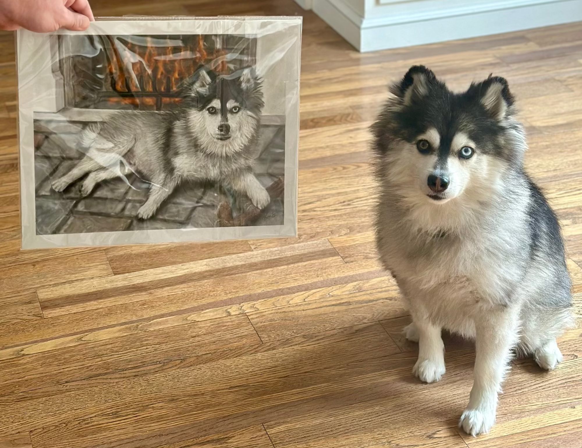 Miller sitting next to his own pet portrait, by Kris Horton