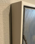 Close up corner of the framed canvas painting by kris Horton, the Dogwood