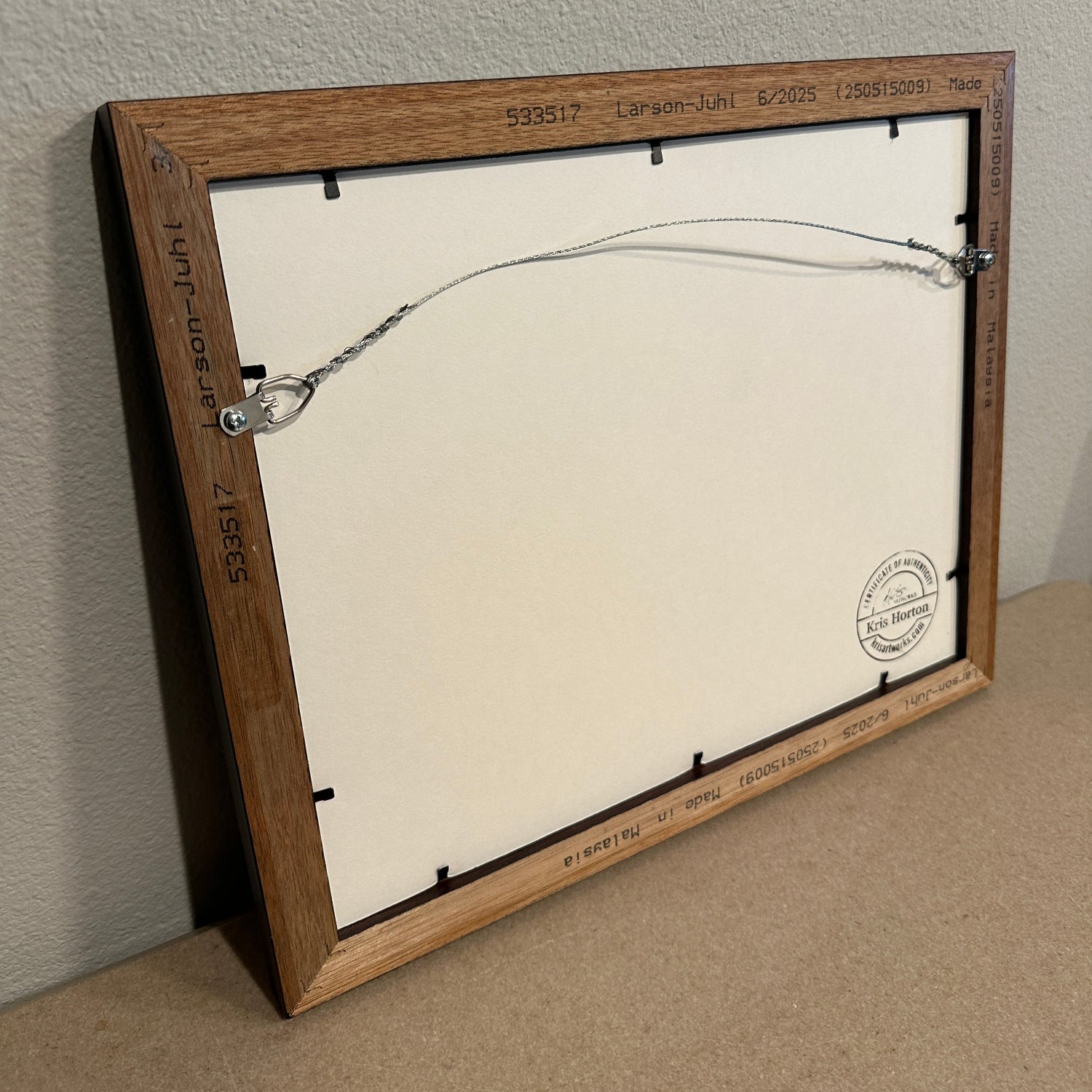 Back of wooden framed original painting by Kris Horton with wire hanger