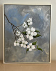 Framed painting by Kris Horton of a branch with dogwood flowers on a textured wall.