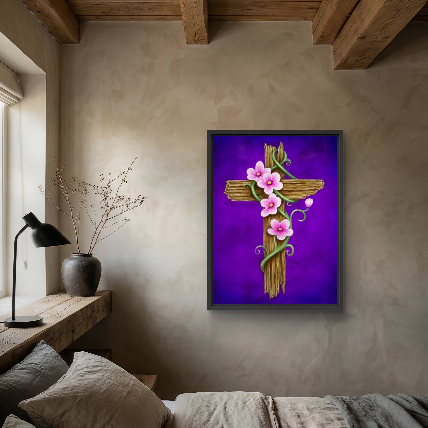 Decorative cross painting by Kris Horton with flowers on a purple background in a bedroom setting.