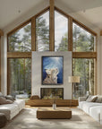 Believe bobcat painting by Kris Horton over a fireplace in a cathedral style living room with large windows.