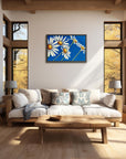 Daisy Days daisy painting by Kris Horton framed over couch in living room with large windows.