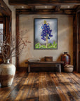 Texas Bloom No. 1 a bluebonnet painting by Kris Horton, framed and hanging in a rustic entryway with wood floors.