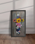 Framed painting of Cross in Bloom by Kris Horton leaning against a wall.