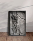 black framed artwork by Kris Horton of Bound - a black and white painting of an old fence post wrapped in barb wire.