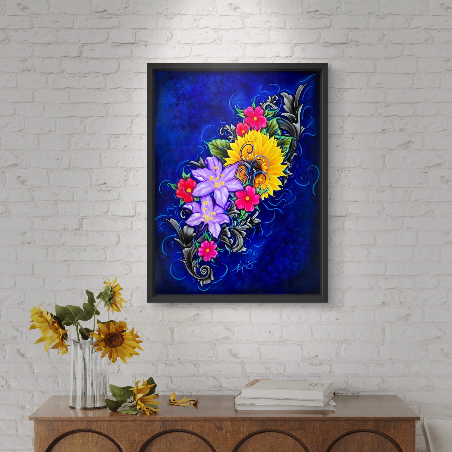 Framed floral artwork named Color of Happiness on a white brick wall with a wooden console table.