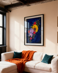 Framed painting of The Color of Happiness a vibrant floral with a blue background in a modern living room.