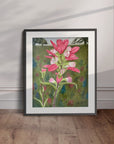 Black framed floral painting by Kris Horton of Texas Bloom No. 2 displayed leaning against the wall.