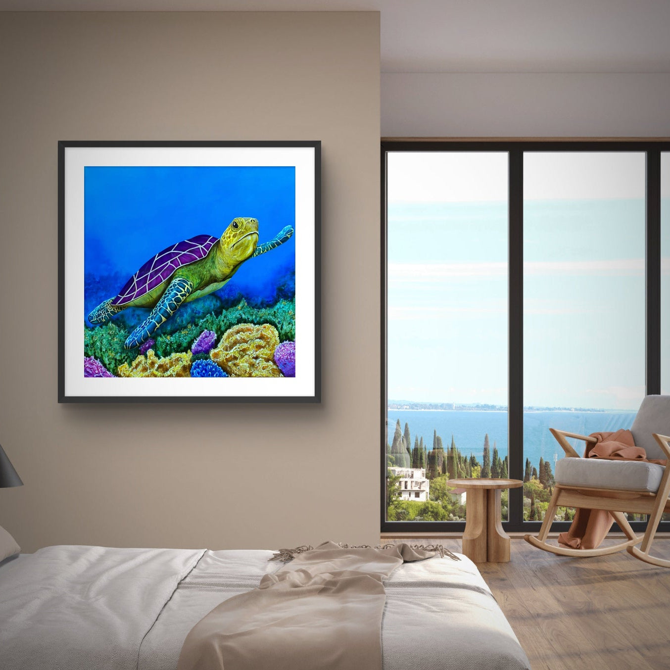 Framed painting by Kris Horton of Sea of Colors a turtle swimming over coral on a wall in a modern bedroom with a view of the ocean.