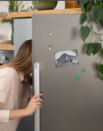 The magnet with the My America painting on a refrigerator.