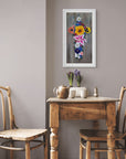 Framed floral cross print by Kris Horton hanging on the wall above a kitchen table.