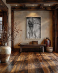 Wood framed Bound painting by Kris Horton that is barb wire wrapped around a fence post in a wooden rustic entry way.