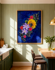 Framed painting of The Color of Happiness by Kris Horton, a vibrant collection of flowers on a blue background hanging in a kitchen with green wall.