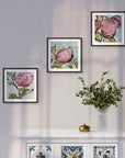 Framed abstract floral prints on a wall above a decorative cabinet with patterned doors, artworks by Kris Horton