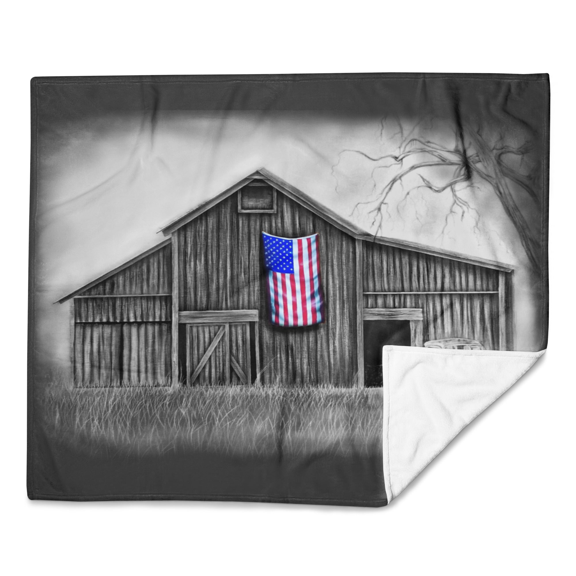 Blanket with a black and white barn design featuring an American flag, on a white background.