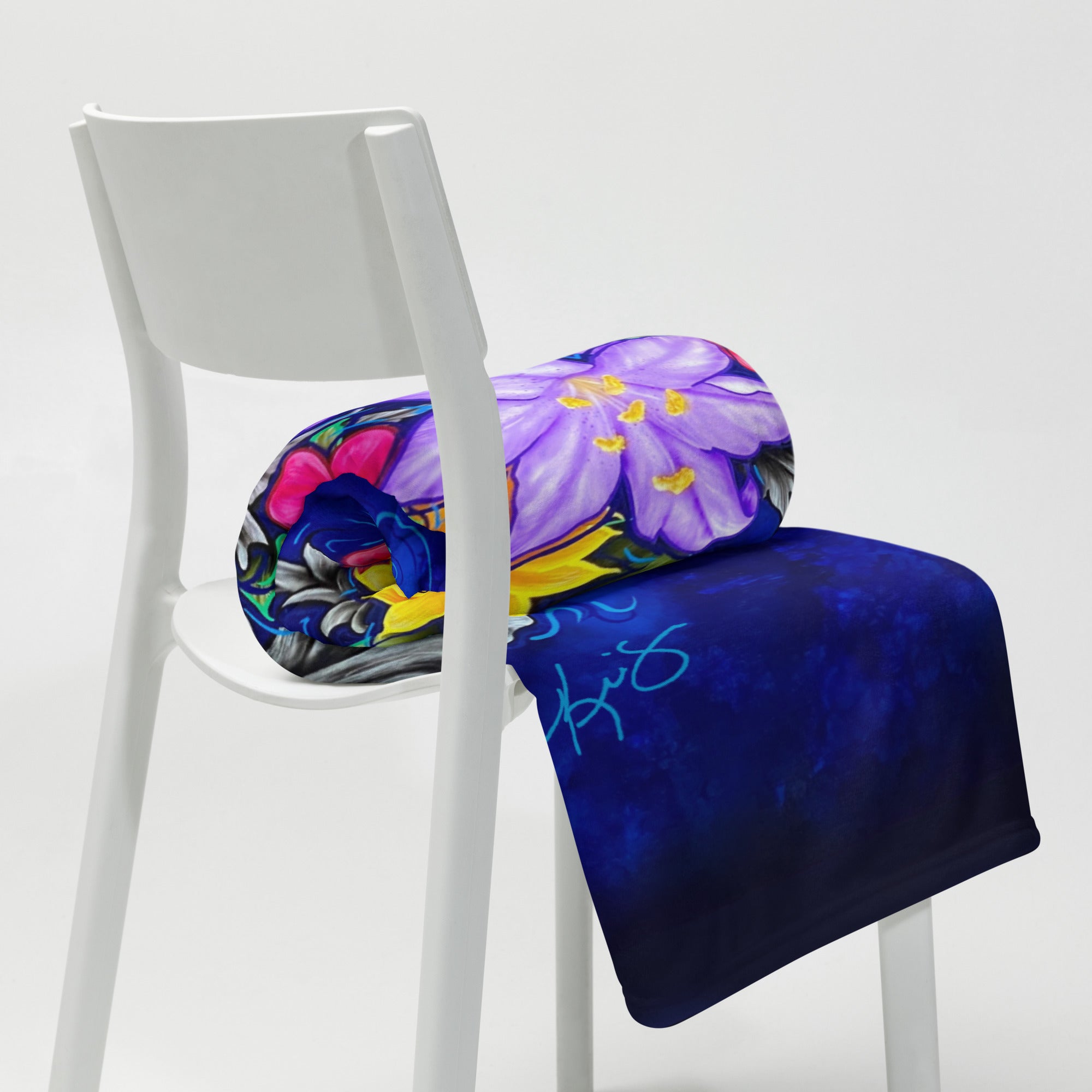 Colorful folded blanket with floral design by Kris Horton