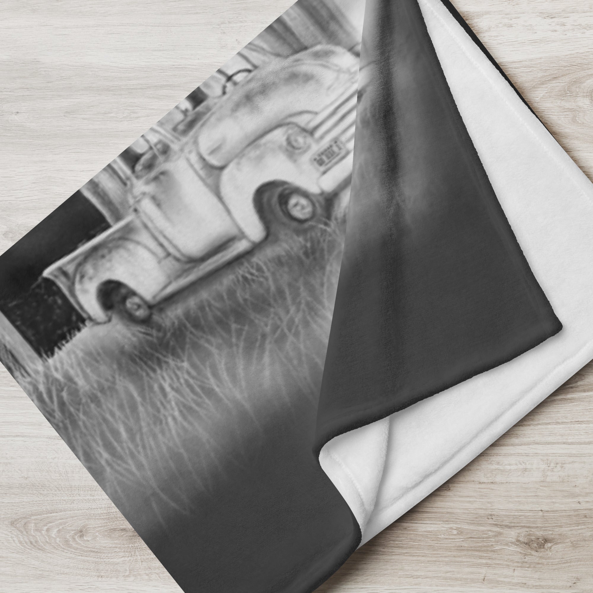 Fleece blanket with a black and white car design on a wooden surface, americana painting by Kris Horton