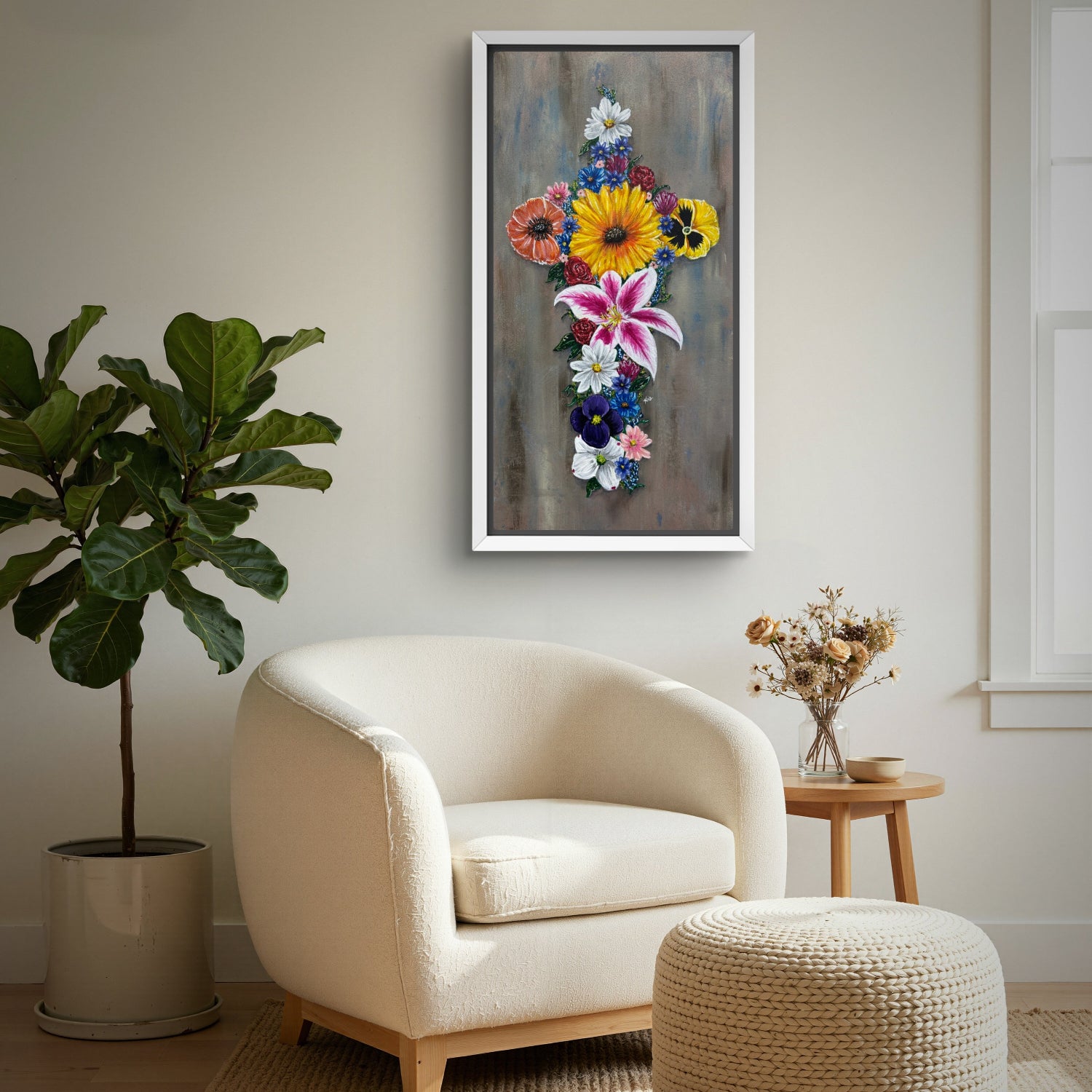 Framed painting of Cross in Bloom which is a cross made of colorful flowers above a chair in a reading nook.