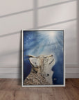 White framed artwork Believe a bobcat painting  by Kris Horton leaning against a wall.
