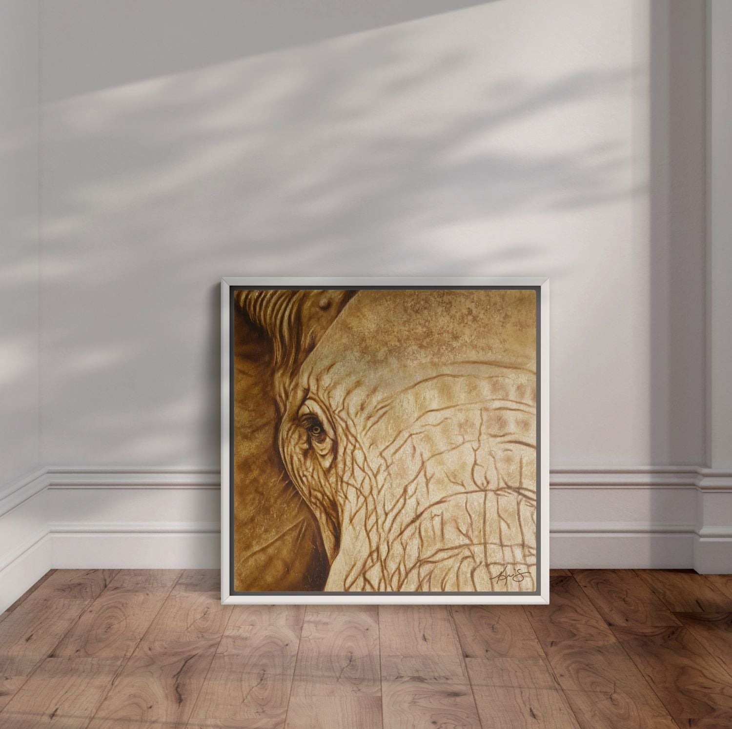 White framed artwork of Strength & Honor a close up of an elephant's head in sepia.