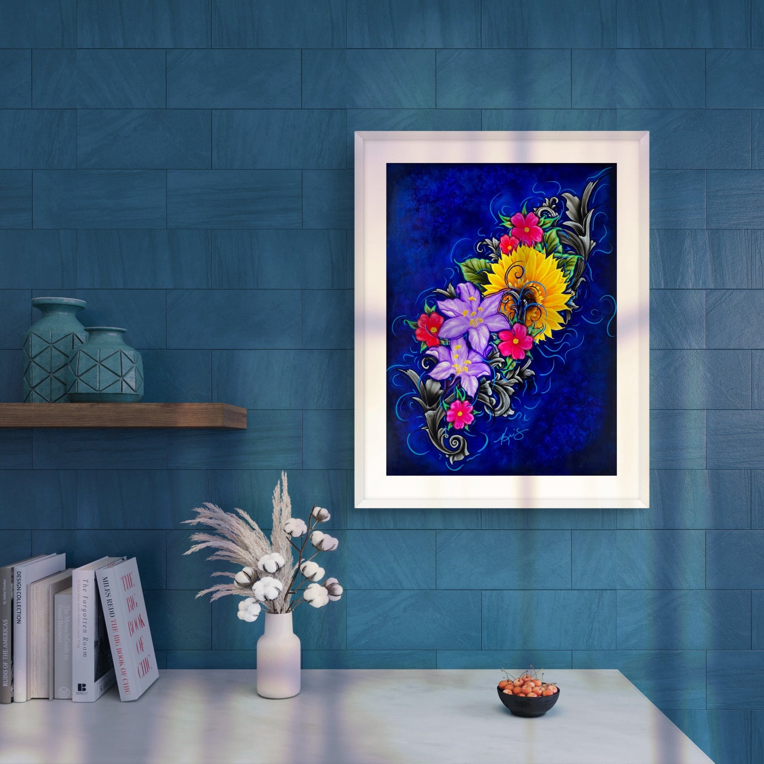 White framed painting of colorful flowers on a blue wall.