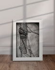 White framed artwork by Kris Horton of an old fencepost with barb wire.